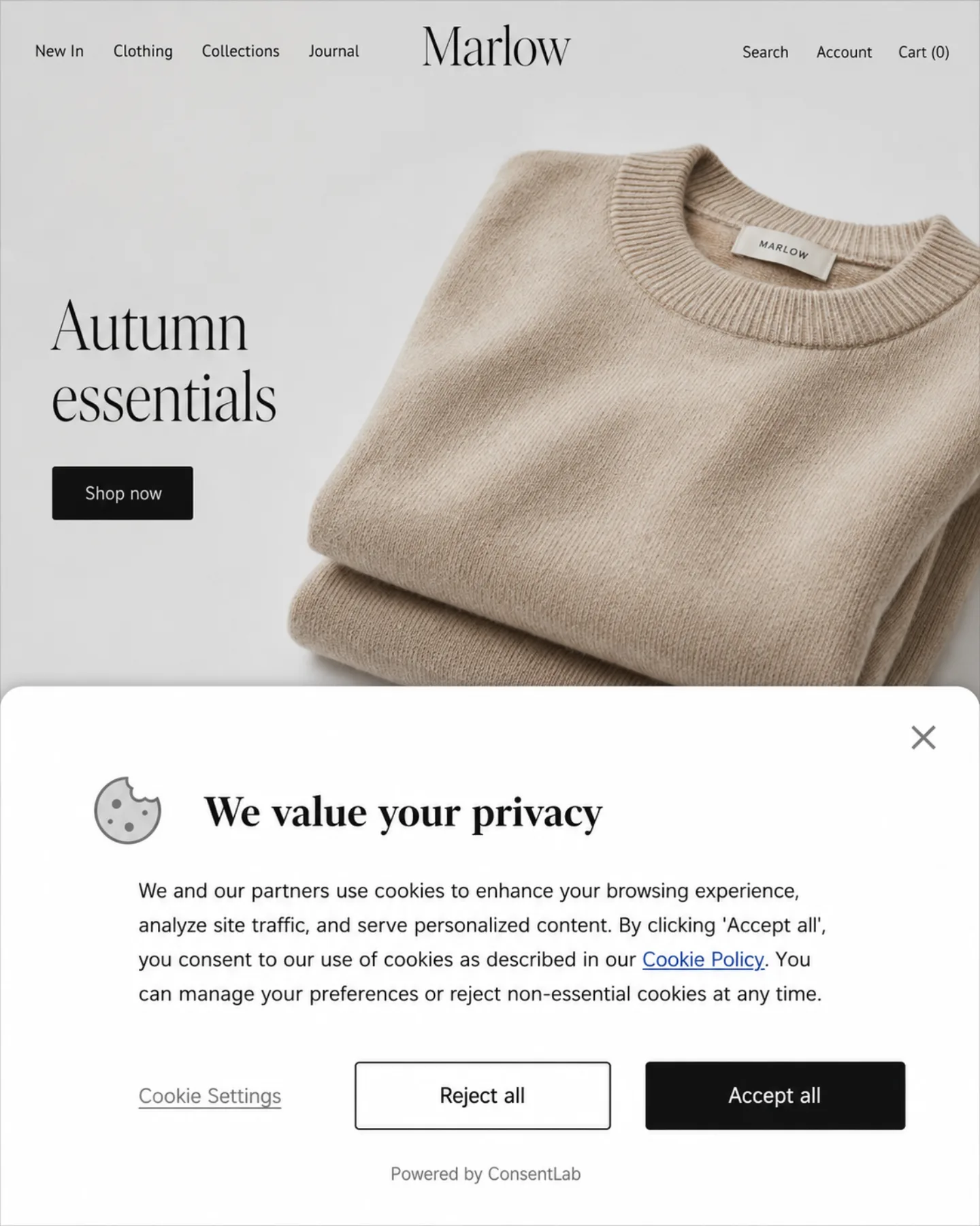 Marlow Apparel e-commerce homepage with a cookie consent banner overlaying the bottom half of the screen. The banner heading reads 'We value your privacy' with a paragraph of consent copy and three controls: a 'Cookie Settings' text link, a 'Reject all' button with a thin border, and a solid black 'Accept all' button. A small 'Powered by ConsentLab' attribution sits at the bottom. The 'Autumn essentials' storefront with a folded beige knit sweater photo is dimmed and partially visible above the banner.