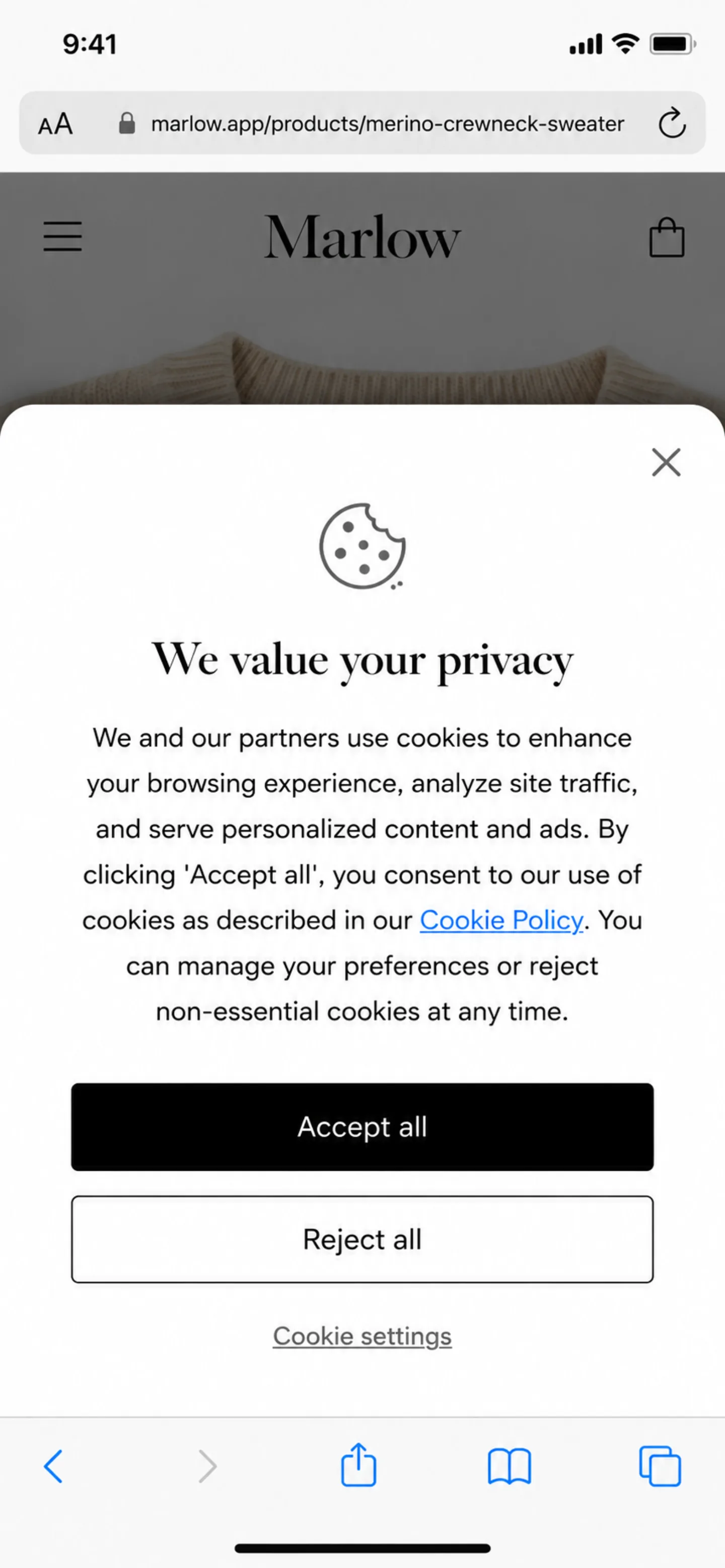 A screenshot of mobile Safari on an iPhone showing a cookie consent banner taking over roughly 60 percent of the screen on the Marlow Apparel storefront. The banner heading reads 'We value your privacy', followed by a paragraph of consent copy with an inline 'Cookie Policy' link. Three stacked full-width controls sit below the copy: an 'Accept all' button, a 'Reject all' button, and a 'Cookie settings' text link. Only a thin strip of the underlying product page, with the Marlow wordmark and the top edge of a sweater photo, remains visible above the banner.